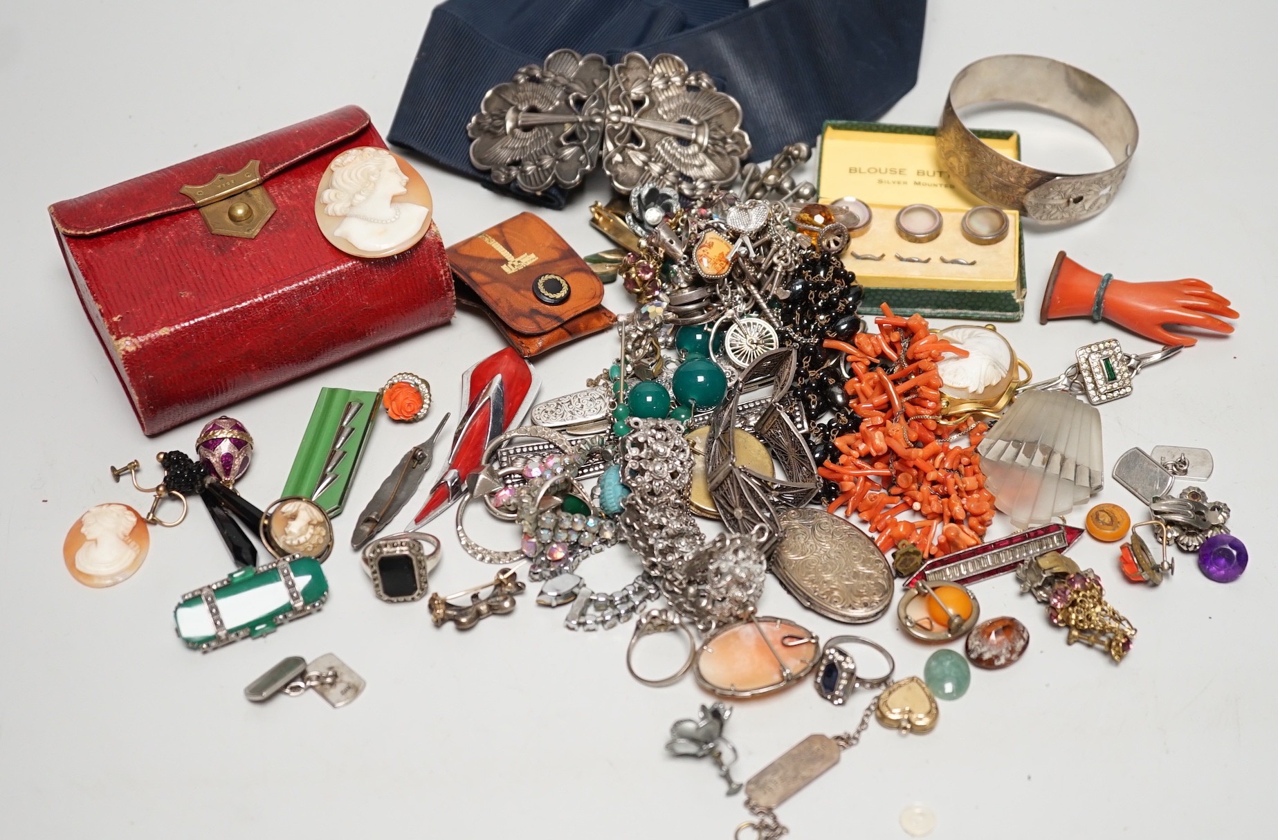 Assorted costume jewellery and other items including a silver belt buckle and enamelled egg pendant.